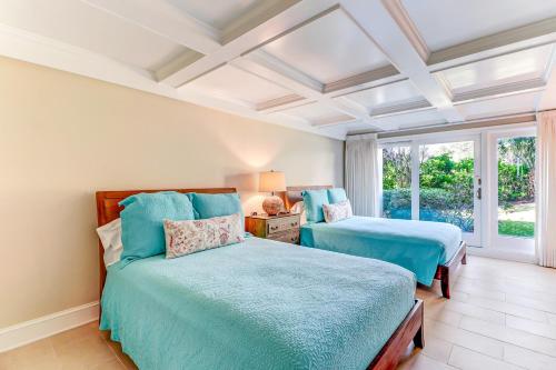a bedroom with two beds and a window at Captains Court 1019 in Fernandina Beach