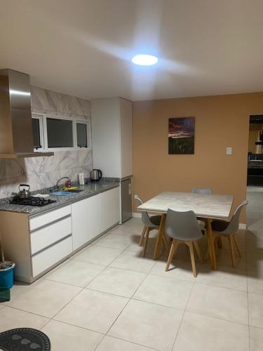 a kitchen with a table and chairs in a room at Departamento Kuyen in Malargüe