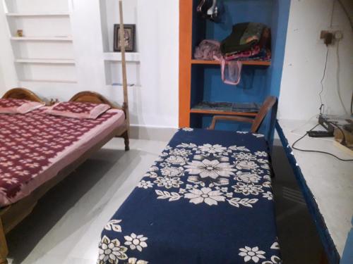 a room with a bed and a table with a blanket at Sudha Kutir Puri in Puri