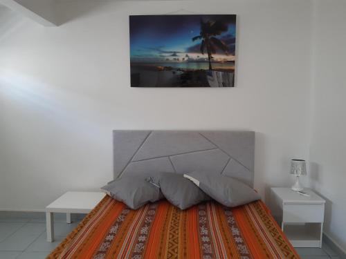 Postel nebo postele na pokoji v ubytování Les ptits flamboyants