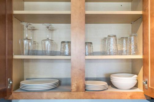 a cabinet filled with dishes and glass jars at Affordable 1BD Keystone in Indianapolis