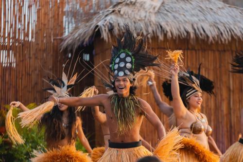 a group of women dancing in front of a crowd at Royal Lahaina Resort & Bungalows in Lahaina