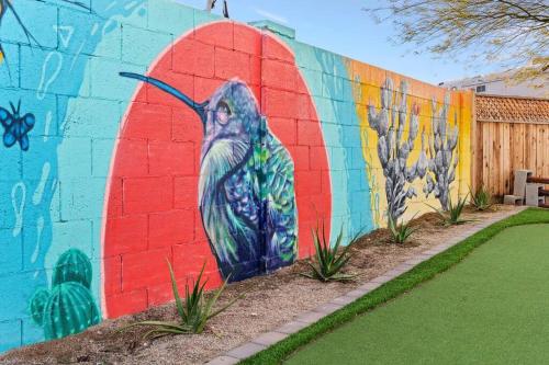 a mural of a bird painted on a wall at The Hummingbird House, Sauna & Mountain Views! in Phoenix