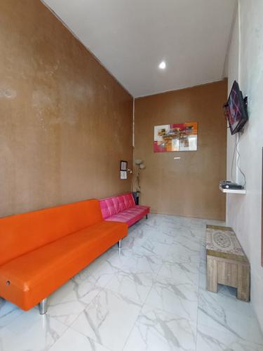 a living room with a couch and a table at Villa Lilly in Batu