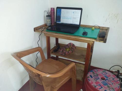 a desk with a laptop computer on top of it at Rismin's Home Stay in Divulpitiya