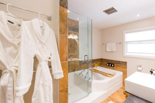 a bathroom with a shower and a sink at Serene Waterfront Escape with Pool, Hot Tub, Pet-Friendly Haven, & Breathtaking Views in Kelowna