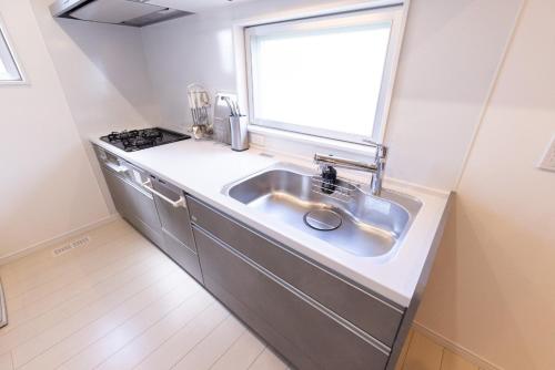 a kitchen with a sink and a window at NAOX I in Miyako Island