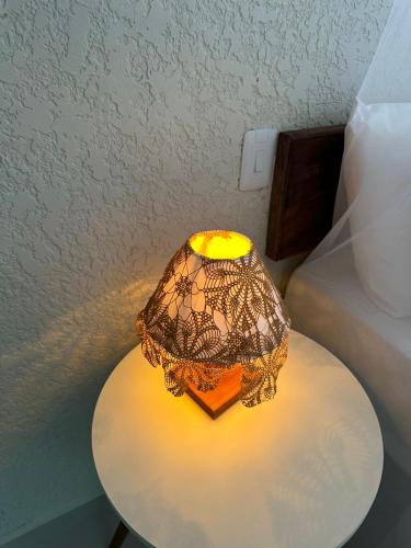 a lamp on a table in a room at Pousada Preciosa do Arraial - com Natura e L'Occitane - recém inaugurada in Arraial d'Ajuda