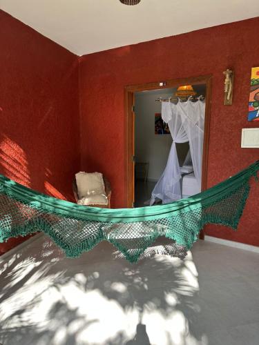 a room with a hammock in front of a mirror at Pousada Preciosa do Arraial - com Natura e L'Occitane - recém inaugurada in Arraial d'Ajuda