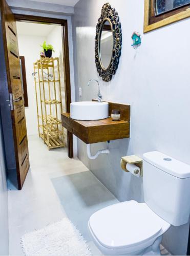 a bathroom with a toilet and a sink at Casa Odara Trancoso in Trancoso