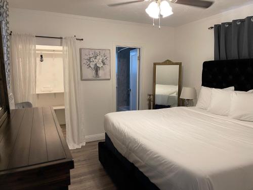a bedroom with a large white bed and a window at Americas Best Value Inn Royal Carriage in Jamestown
