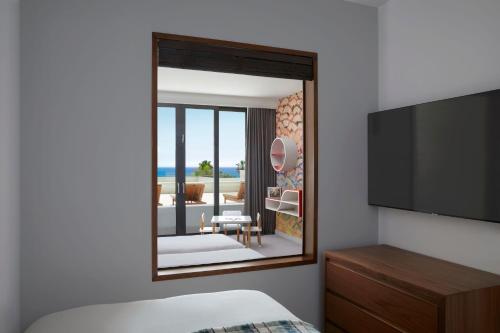 a bedroom with a view of a living room at Parklane, a Luxury Collection Resort & Spa, Limassol in Limassol
