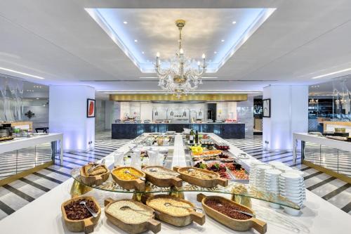 a buffet line with breads and pastries on display at Parklane, a Luxury Collection Resort & Spa, Limassol in Limassol