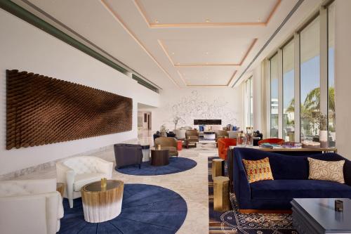 a living room with blue couches and chairs at Parklane, a Luxury Collection Resort & Spa, Limassol in Limassol