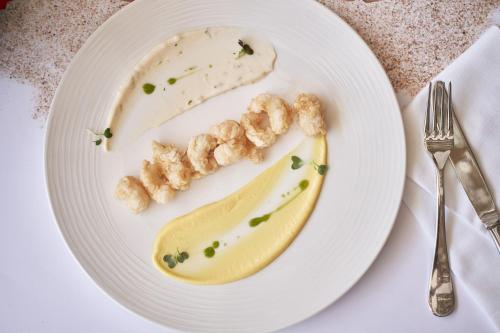 a plate of food with a banana on it at Parklane, a Luxury Collection Resort & Spa, Limassol in Limassol