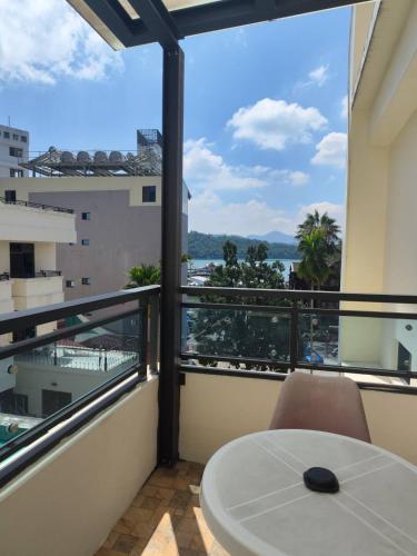 a balcony with a table and a view of the ocean at 逐鹿森林民宿-無電梯 in Yuchi
