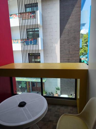 a table and a chair in front of a window at 逐鹿森林民宿-無電梯 in Yuchi