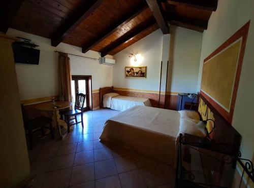 a bedroom with a bed and a table in it at Cilento Antico in Stella Cilento