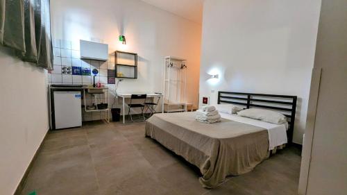 a bedroom with a bed and a desk in it at Accomodation Libertino in Tropea