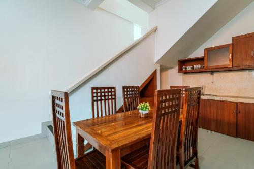 a dining room with a wooden table and chairs at Umah Kita in Seminyak
