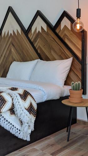 a bedroom with a large bed with a wooden headboard at Smeštaj Skuratenko in Malo Laole