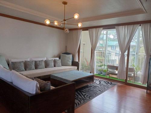 a living room with a couch and a table at Minesview condo in Baguio