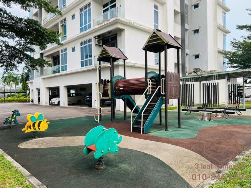 a playground with a slide in front of a building at Senai Garden Apartment near Senai Airport&JPO 