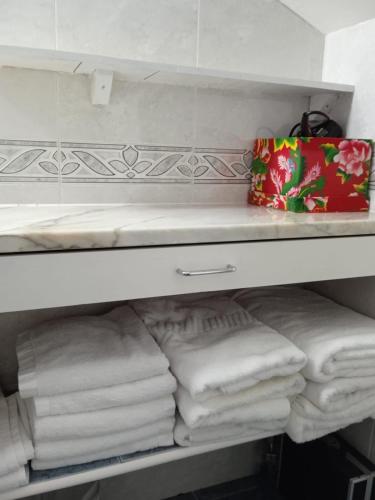a shelf with a bunch of towels on it at A Casiña de Mera in Santa Marta de Ortigueira