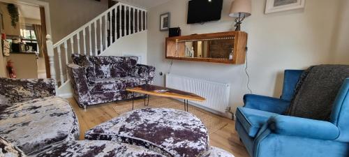 a living room with two chairs and a table at Frontview Cottage - Two Bedroom - Sleeps 6 guests in Ballynahinch