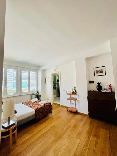 a bedroom with a bed and a wooden floor at Brera Apartment in Milan