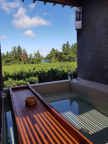a swimming pool with a bowl on a wooden deck at U.G.SODAM (Uigwisodam) in Seogwipo