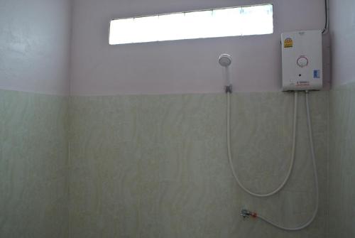 a shower in a bathroom with a window and a shower at Mama Leurth Sunset Guesthouse in Don Det