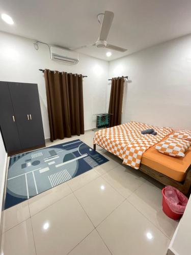 a room with two beds and a carpet in it at Homestay Azirah-musleem preferred in Pekan