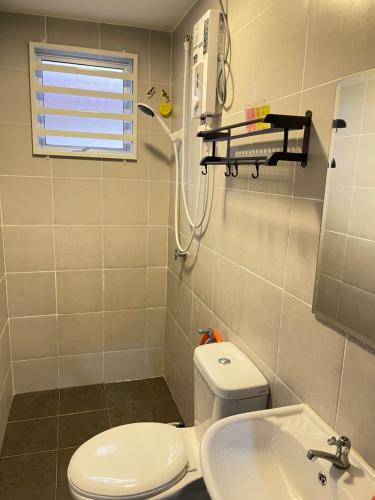 a bathroom with a toilet and a sink at Homestay Azirah-musleem preferred in Pekan