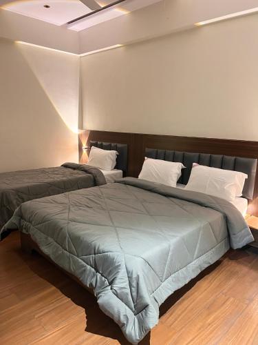a bedroom with two beds in a room at Hotel Lakshmi Residency in Visakhapatnam
