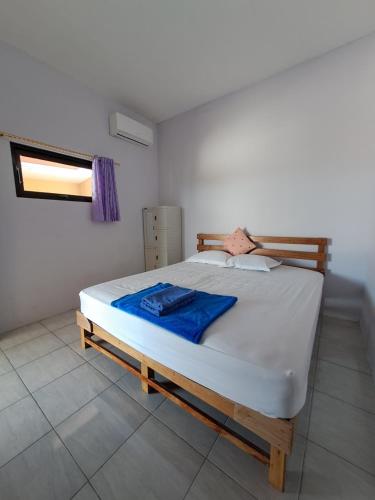a bedroom with a large bed in a room at Azza karimunjawa in Karimunjawa