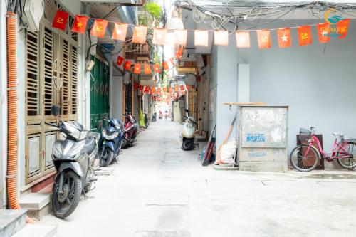 a street with scooters parked on the side of a building at Natural Light STU 402 Near Uncle Ho's Mausoleum in Hanoi