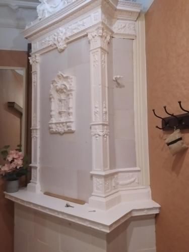 a white display case with a antler on a wall at Julia Lacplesa Apartments in Rīga