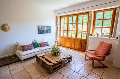 a living room with a couch and a coffee table at La colonie - Haut Valromey in Chavillieu