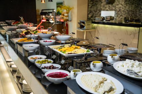 a buffet line with many different types of food at Elite Byblos Hotel in Dubai