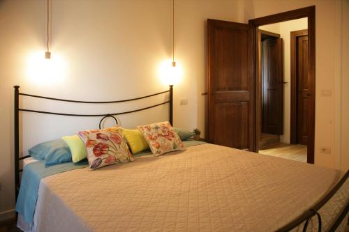 a bedroom with a bed with two pillows on it at Maison Rosina con ampia vista in borgo del 1400 in Marsciano