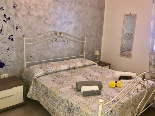 a bedroom with a bed with a white and blue comforter at Residenza San Michele in Tropea