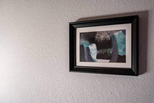 a picture frame hanging on a wall at 日向サーフキャンプ202 in Hyuga