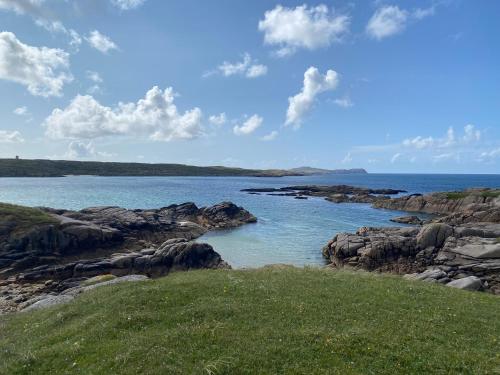 a view of a body of water with rocks at Kincasslagh in Gortnasate
