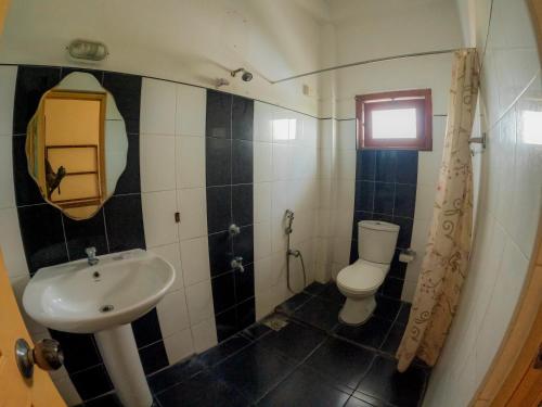 a bathroom with a sink and a toilet at Hotel Blackstone in Hambantota