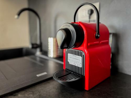 a red machine sitting on top of a counter at Cavour Apartment Center Bardolino in Bardolino