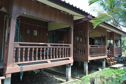 a house with a porch and a balcony at Dalom Guesthouse in Don Det
