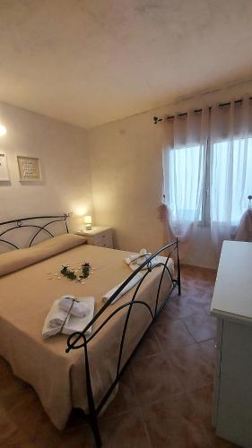 a bedroom with a large bed with flowers on it at Donnigheddu in Rudalza