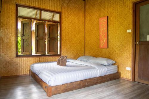 Ένα ή περισσότερα κρεβάτια σε δωμάτιο στο Butterfly Hostel, Pai