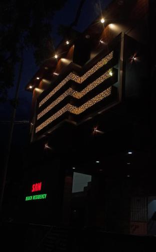 a building with lights on it in the dark at SAN BEACH RESIDENCY in kāraikāl